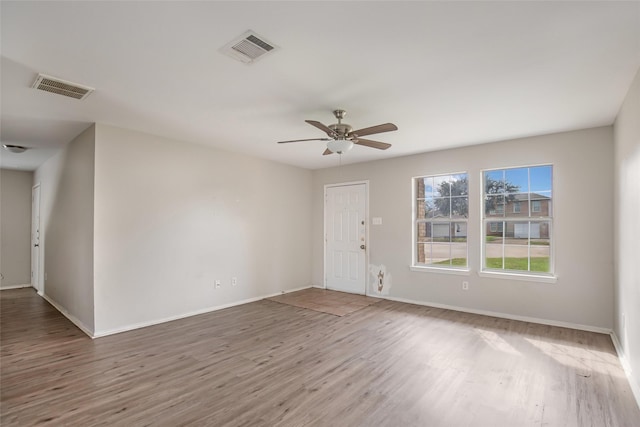 empty room featuring ceiling fan and hardwood / wood-style flooring