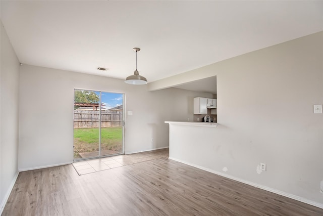 spare room featuring light hardwood / wood-style flooring