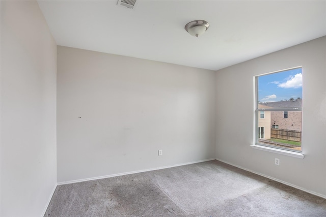 carpeted empty room with a healthy amount of sunlight