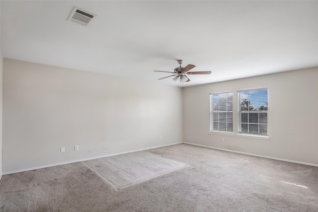 spare room featuring light colored carpet and ceiling fan