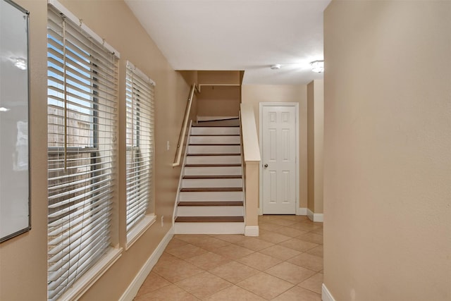 stairway with tile patterned flooring and a wealth of natural light