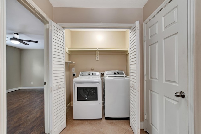 clothes washing area with ceiling fan, light hardwood / wood-style flooring, and washer and dryer