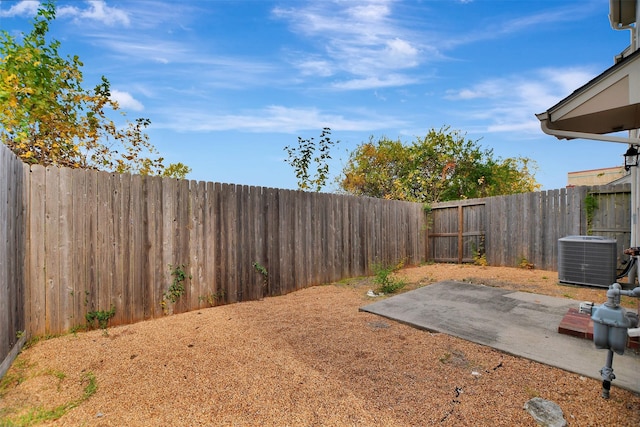 view of yard with cooling unit and a patio area