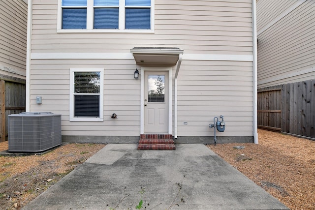 doorway to property with central air condition unit and a patio area