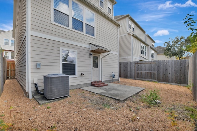 rear view of property featuring a patio area and central air condition unit