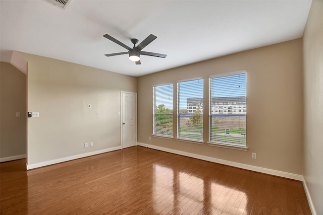 spare room with hardwood / wood-style flooring and ceiling fan