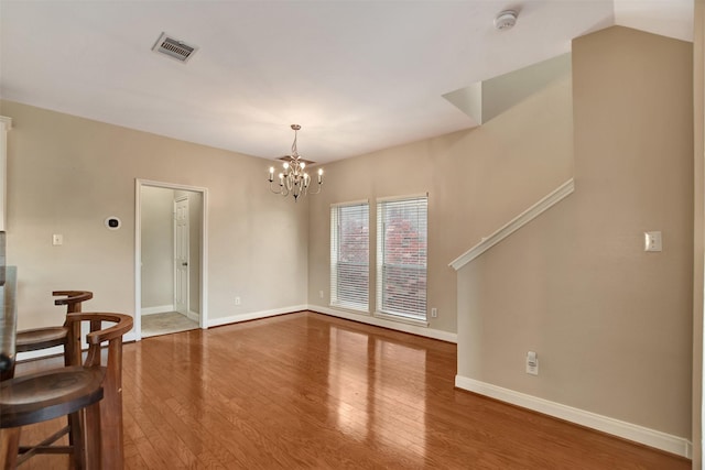 interior space featuring a notable chandelier and hardwood / wood-style flooring