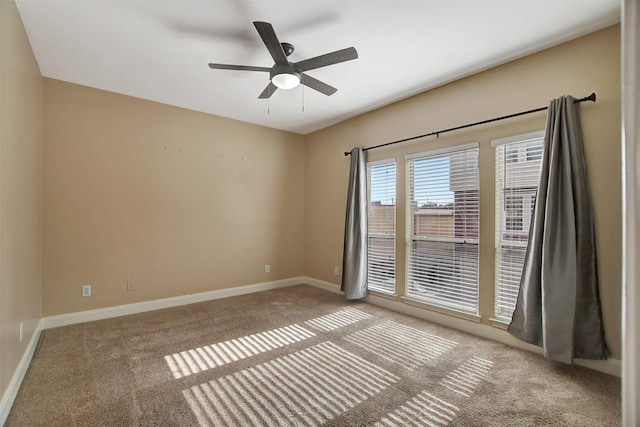 carpeted empty room featuring ceiling fan