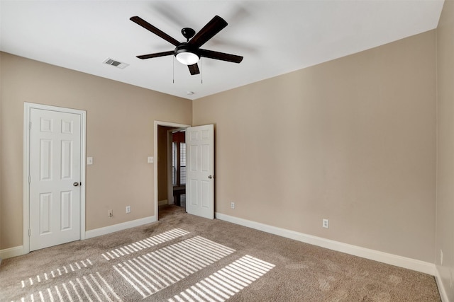 unfurnished bedroom featuring light colored carpet and ceiling fan