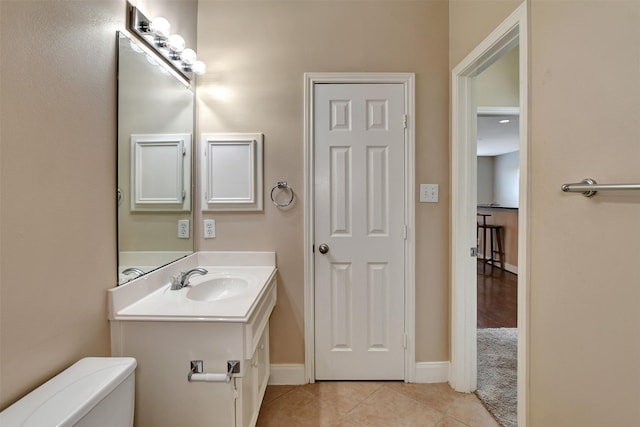 bathroom with tile patterned floors, vanity, and toilet