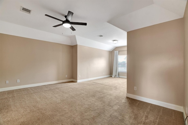 carpeted empty room with ceiling fan and vaulted ceiling