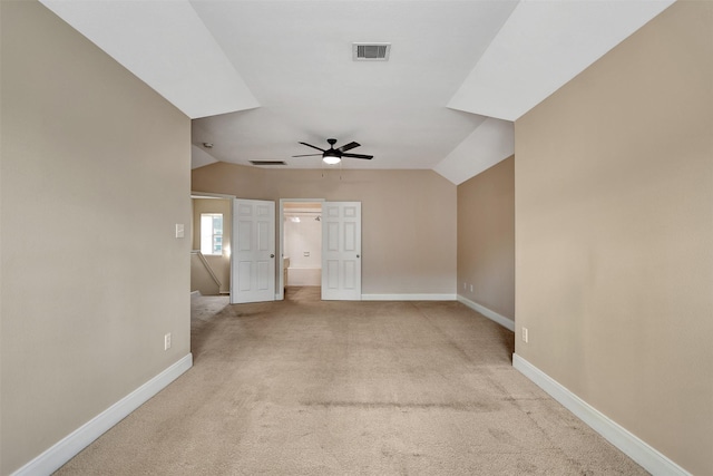 carpeted empty room featuring ceiling fan and vaulted ceiling