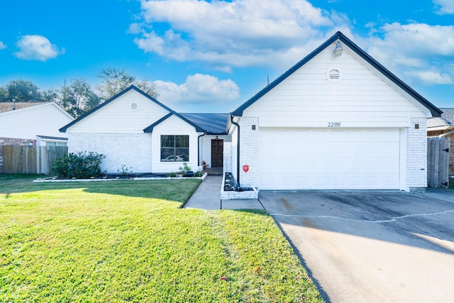 ranch-style house with a garage and a front lawn