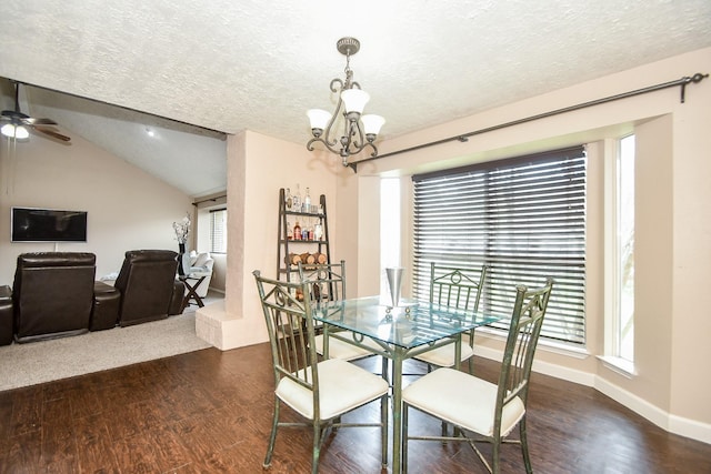 dining space featuring vaulted ceiling, dark hardwood / wood-style flooring, and a textured ceiling