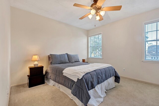 bedroom featuring light colored carpet and ceiling fan