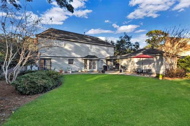 back of house featuring a patio and a lawn