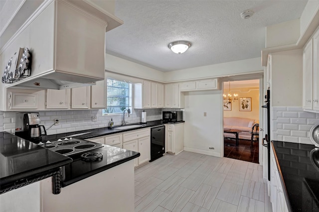 kitchen featuring a notable chandelier, black appliances, a sink, dark countertops, and backsplash