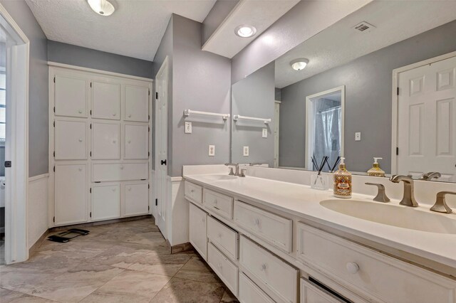 bathroom featuring vanity and a textured ceiling