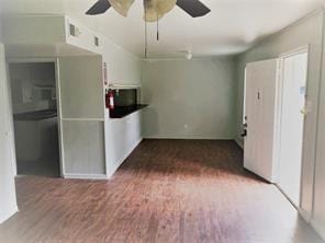 interior space featuring ceiling fan and dark wood-type flooring