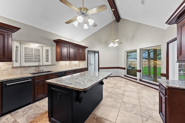 kitchen with a kitchen bar, sink, black dishwasher, beamed ceiling, and a kitchen island