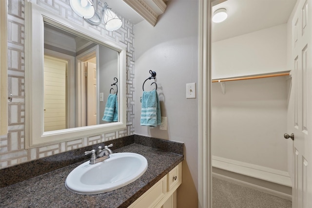 bathroom with a spacious closet and vanity