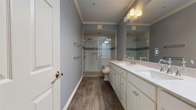 bathroom featuring ornamental molding, vanity, toilet, and a shower with shower door