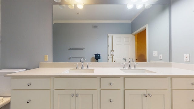 bathroom featuring vanity, toilet, and crown molding