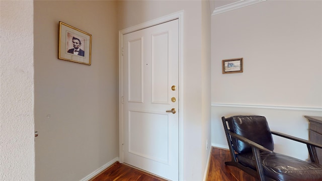 doorway with dark hardwood / wood-style floors and ornamental molding