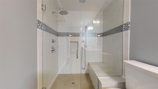 bathroom featuring an enclosed shower and toilet