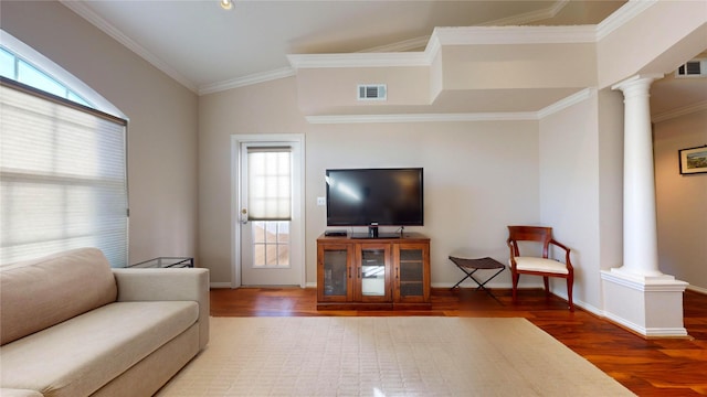 living room with wood-type flooring, ornamental molding, and ornate columns