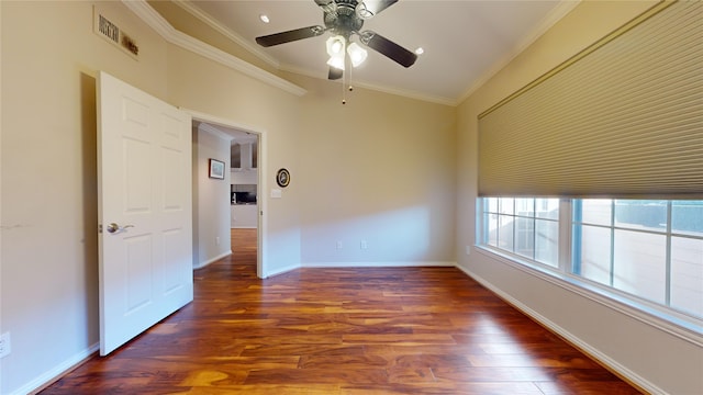 spare room featuring lofted ceiling, dark hardwood / wood-style floors, ceiling fan, and crown molding