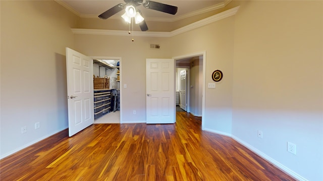 unfurnished bedroom featuring crown molding, dark hardwood / wood-style flooring, and ceiling fan