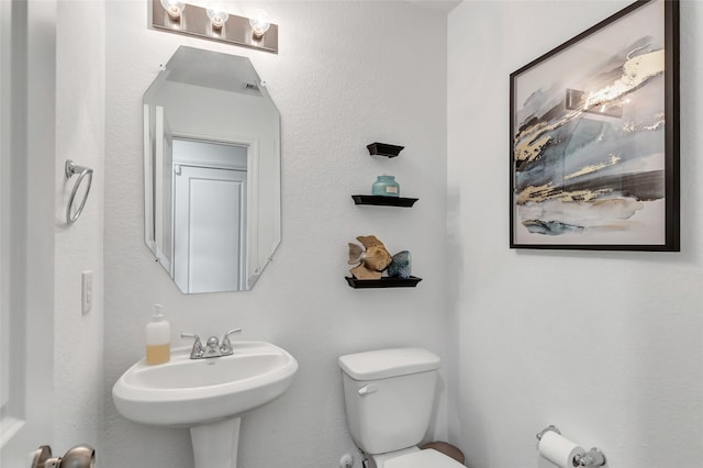 bathroom with sink and toilet