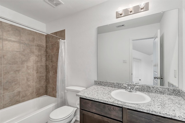 full bathroom with shower / tub combo with curtain, vanity, and toilet