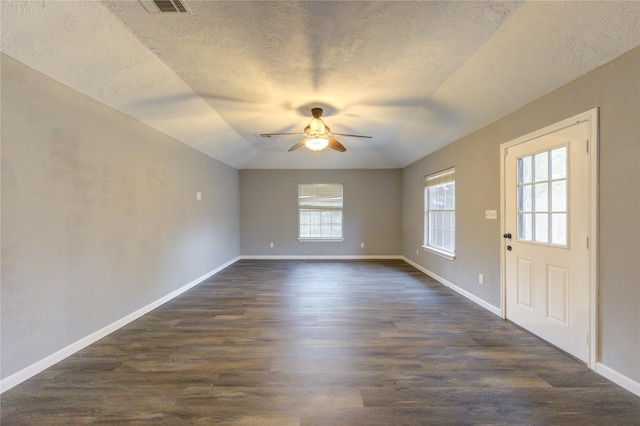 spare room with dark wood-type flooring, ceiling fan, and a textured ceiling