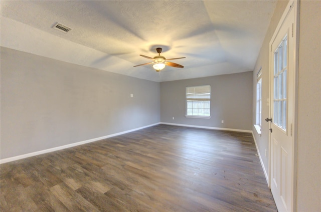 unfurnished room with ceiling fan, dark hardwood / wood-style floors, and a textured ceiling