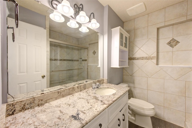 bathroom featuring tile walls, toilet, walk in shower, and vanity