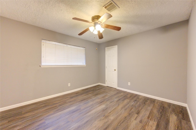 unfurnished room featuring a textured ceiling, ceiling fan, and dark hardwood / wood-style floors