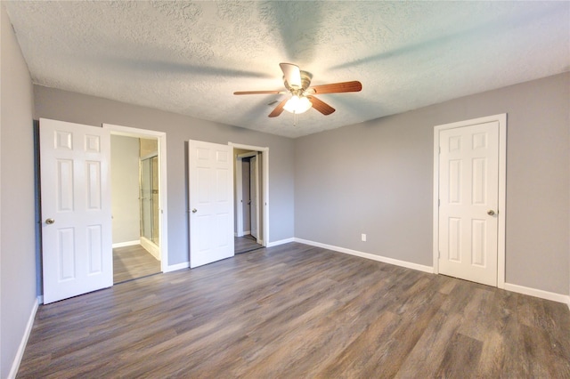 unfurnished bedroom featuring ceiling fan, dark wood-type flooring, and a textured ceiling