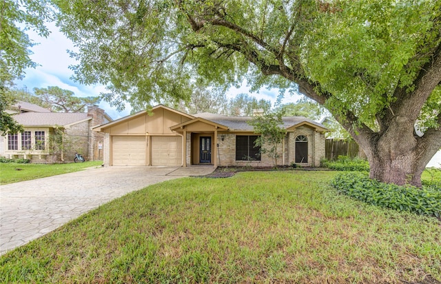 ranch-style home featuring a front lawn and a garage