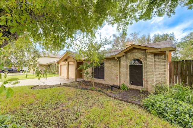 ranch-style home featuring a front yard and a garage