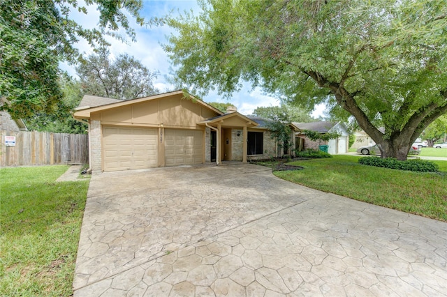 single story home featuring a garage and a front yard