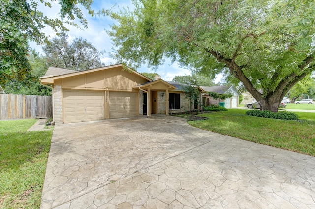 ranch-style house featuring a front yard and a garage