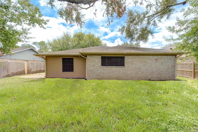 rear view of house with a lawn