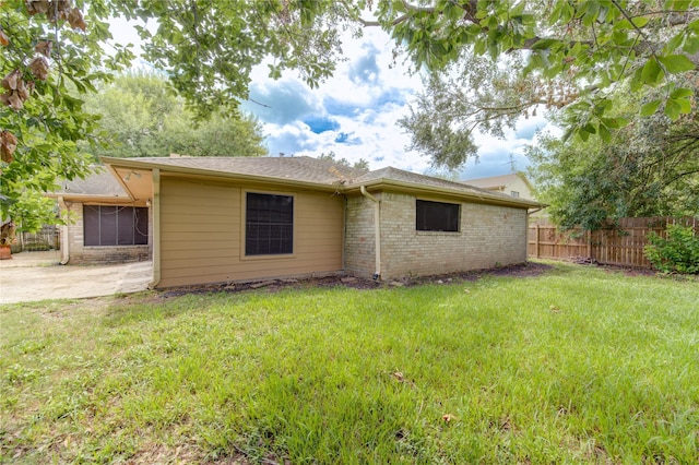 rear view of property with a patio area and a yard