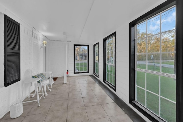 unfurnished sunroom with plenty of natural light and lofted ceiling