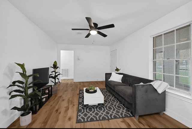 living room featuring ceiling fan and wood-type flooring