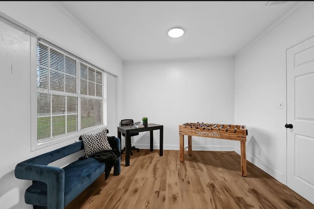 sitting room featuring hardwood / wood-style flooring and ornamental molding