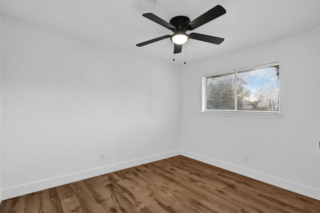 unfurnished room with hardwood / wood-style floors and ceiling fan