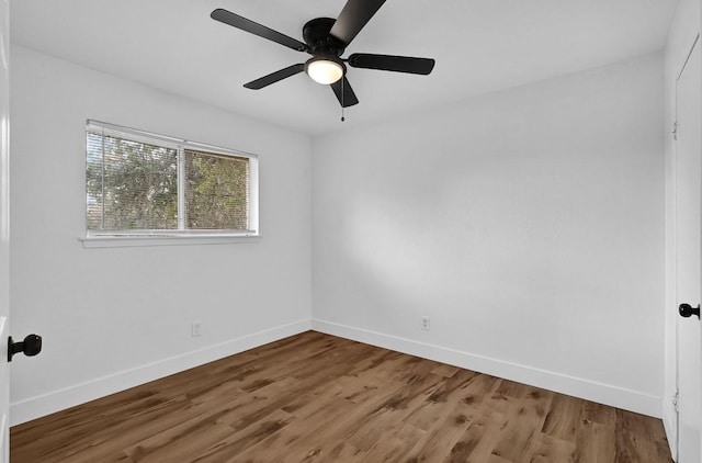 unfurnished room with hardwood / wood-style flooring and ceiling fan